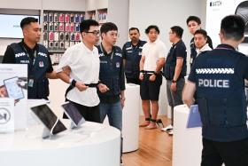 Accused Zhang Tianyu (second from left in white top) walking past Li Xueqi (middle in white top) and Xu Zhaochen (right in white top) inside iStudio store in Bugis Junction on Nov 14.