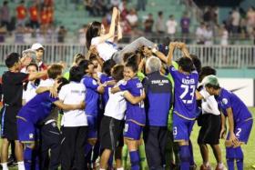 Nualphan Lamsam is hoisted in the air after the Thailand women&#039;s team beat Vietnam in 2014 to qualify for the 2015 Women&#039;s World Cup for the first time.