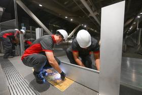 The barriers, which are in four pieces stacked one on top of the other, comprise individual metal panels and connecting columns.