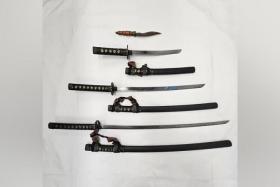 The men were arrested for alleged illegal possession of scheduled weapons including a kukri (knife) and three katana (swords).